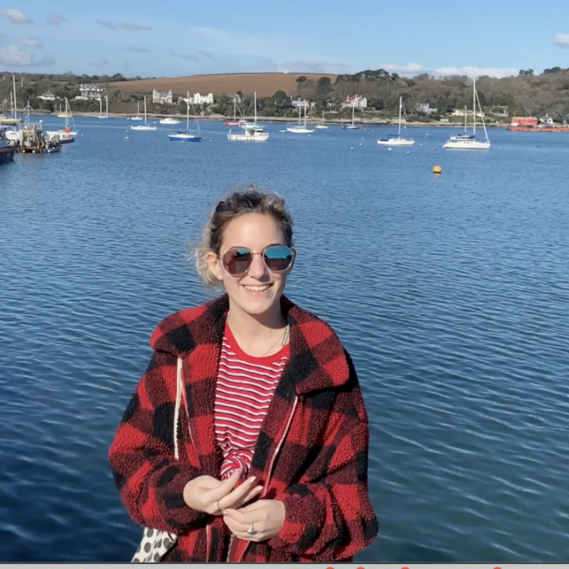 Picture of Amy Wood, student content creator and Ambassador, by the sea in Falmouth.