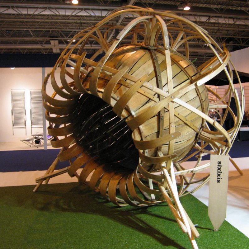 Large wooden sculpture that looks like a sunflower