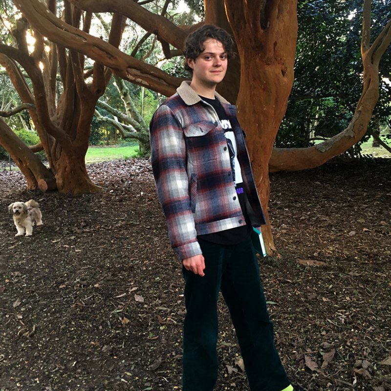 A photograph of Illustration student Rupert Skelton under a tree