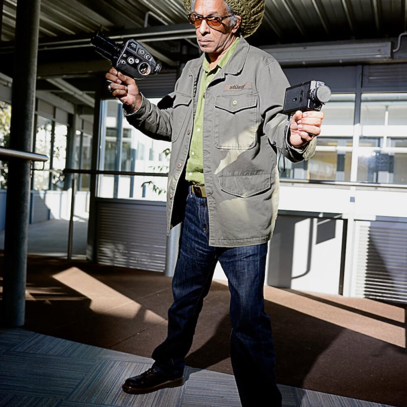 Don Letts holding cine film cameras.