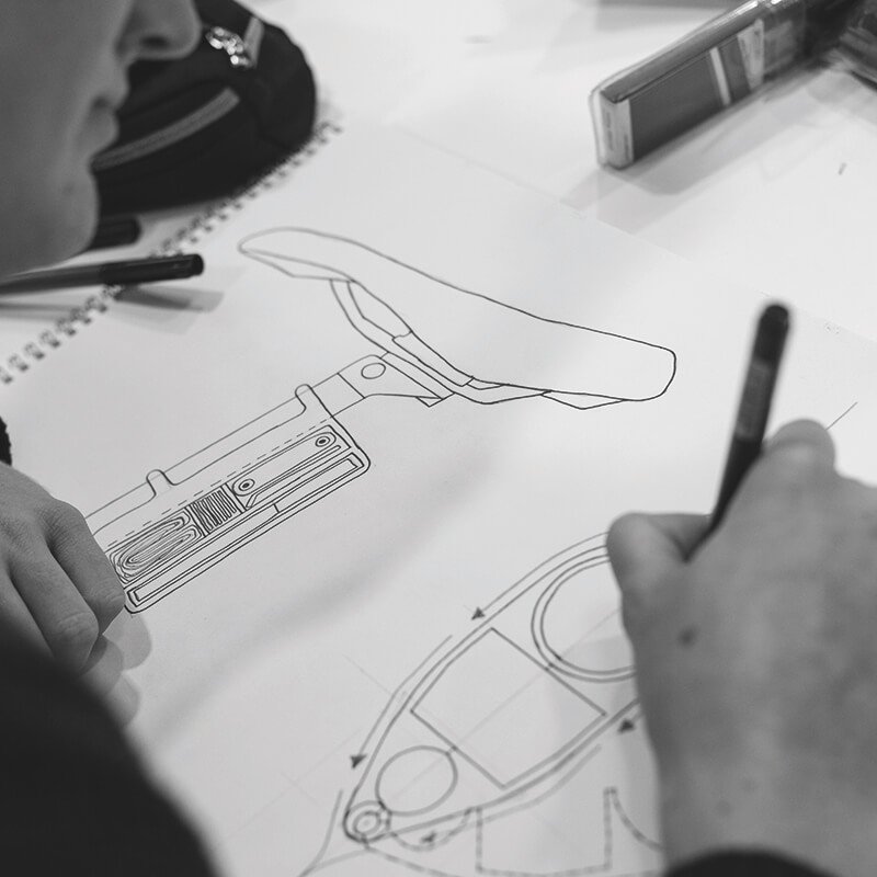 Student drawing design for a bike seat.