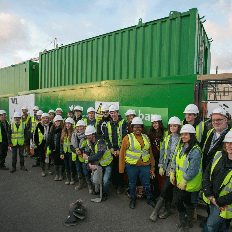 Group of architecture students wearing hard hats and high vis jackets