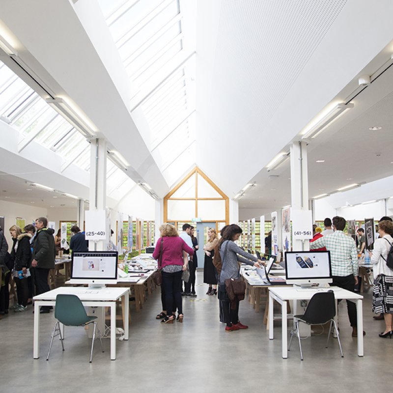 People wandering and looking at work in the graphic design studio.