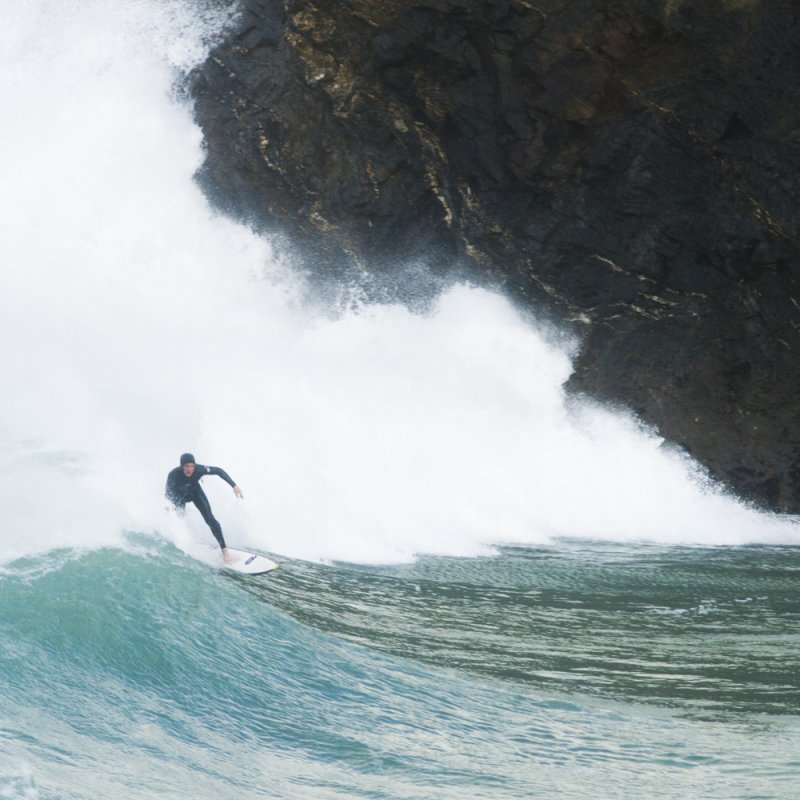 Surfer coming in on large wave.