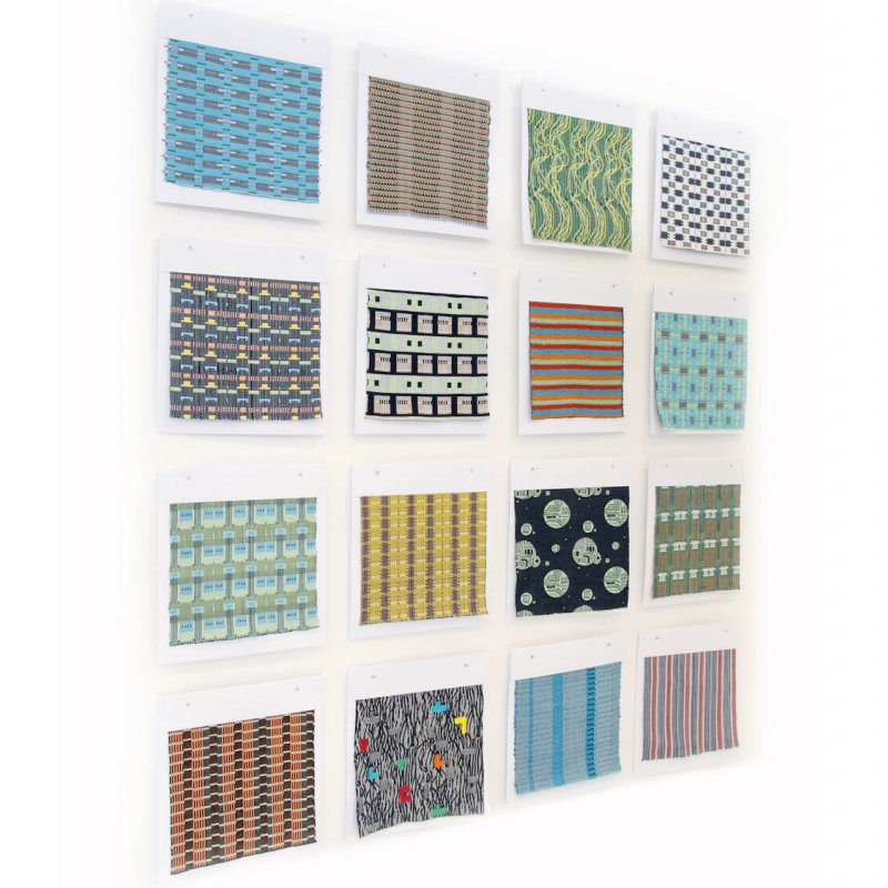 Wall display of different patterned and coloured samples.