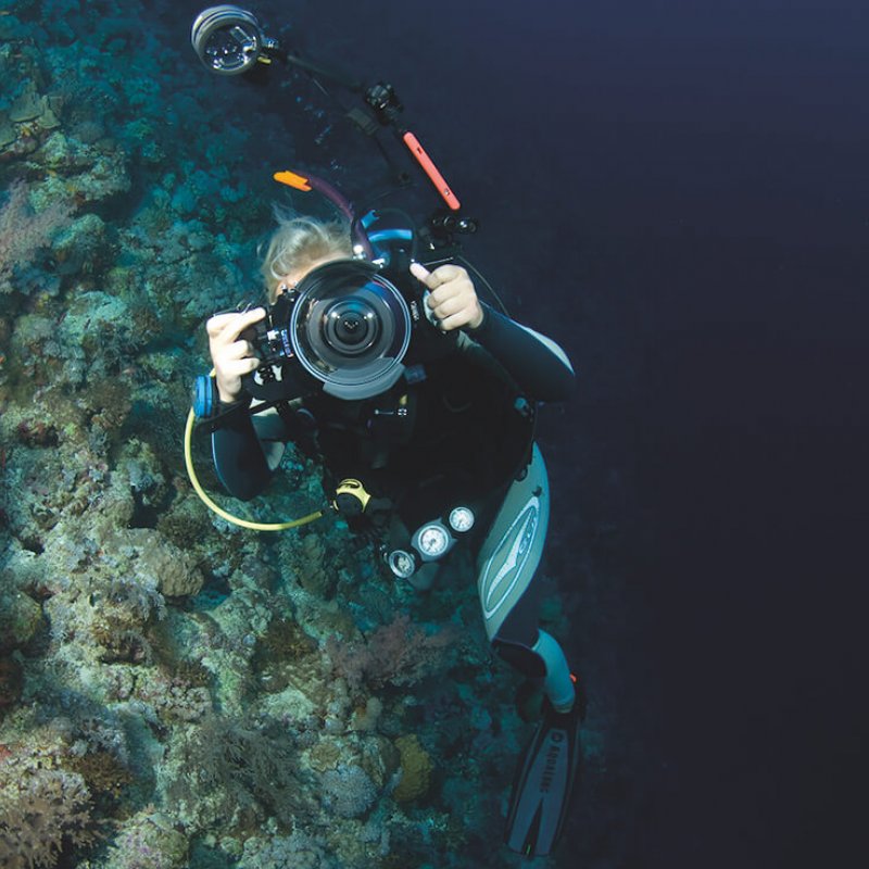 Falmouth University Marine Photography student underwater, pointing camera at the photographer.