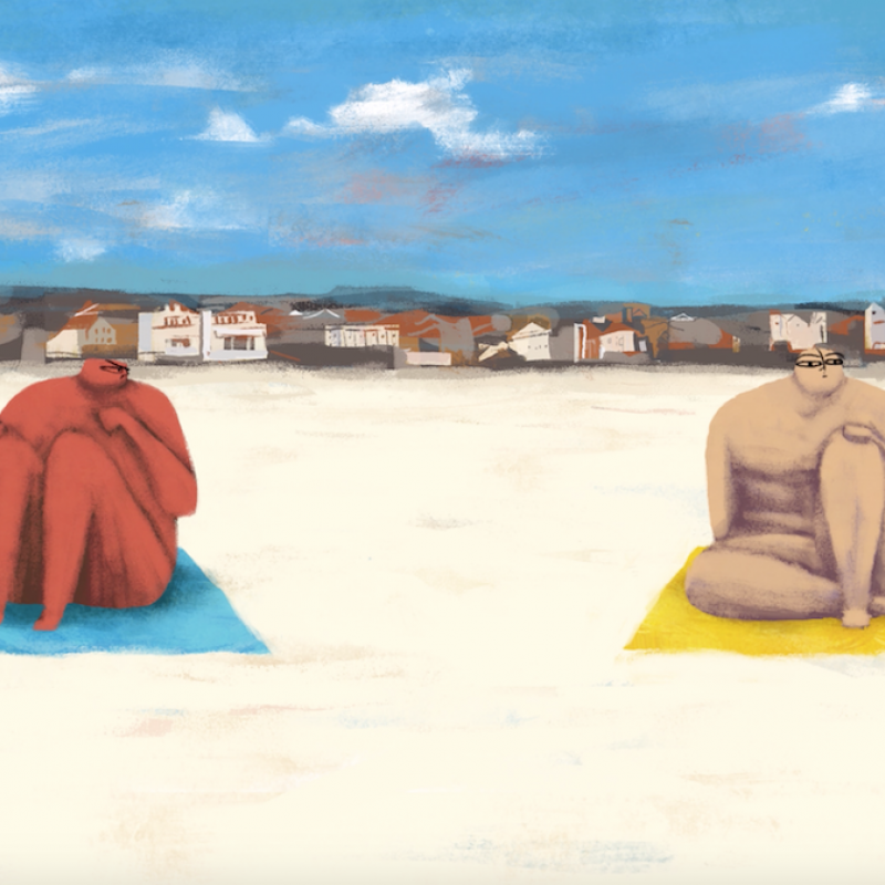 Two figures sitting on towels on the sand