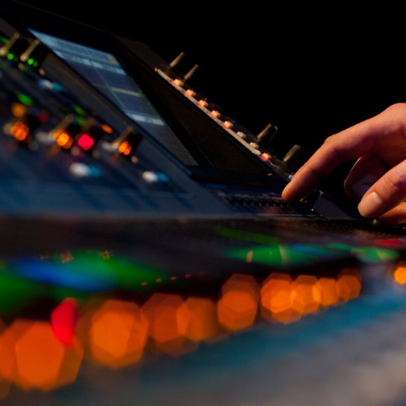 Close up of lights and buttons on mixing desk.