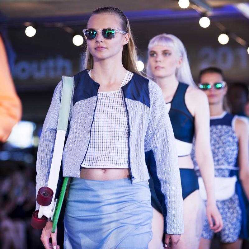 Line of models walking down a catwalk.