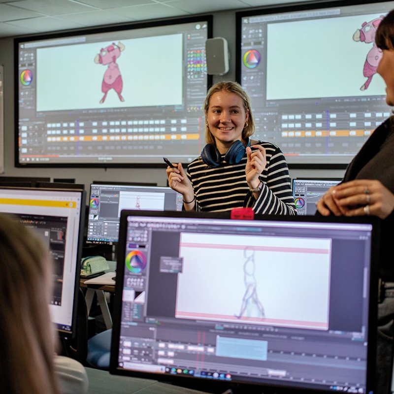Students chatting with each other in animation suite