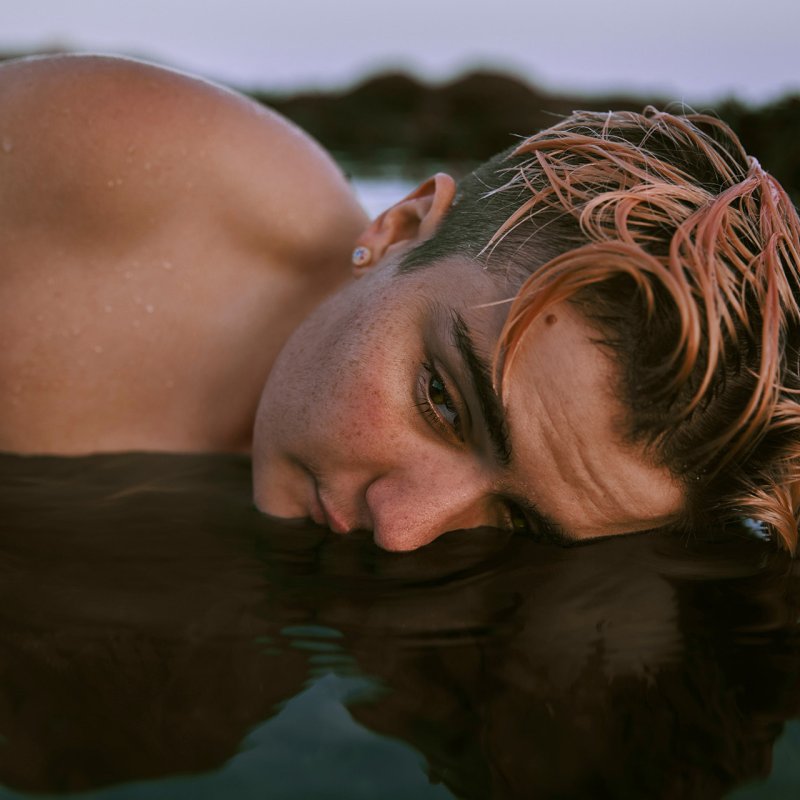 Photography of a woman with half her face in water