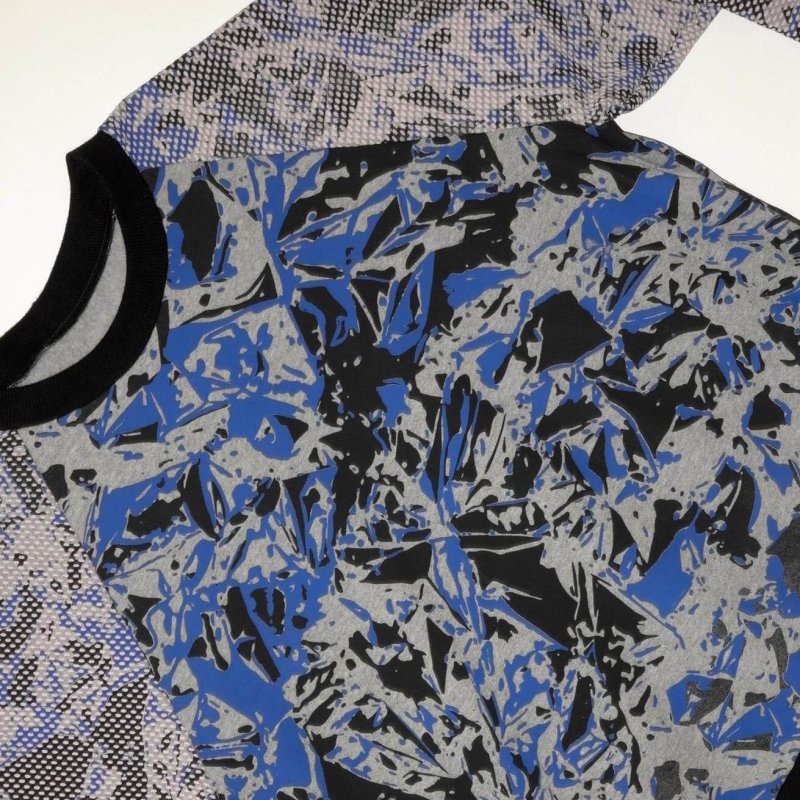 A long sleeve t-shirt with blue, black and grey abstract design