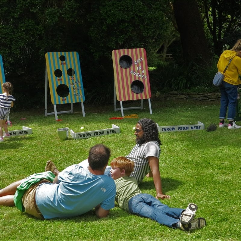Families playing games in the gardens on Falmouth Campus