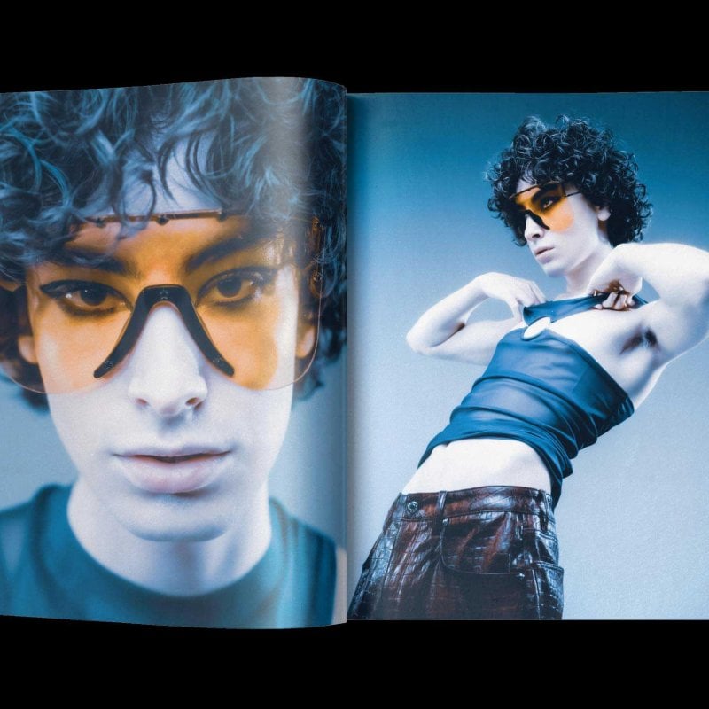 A magazine double page spread featuring a model in orange sunglasses