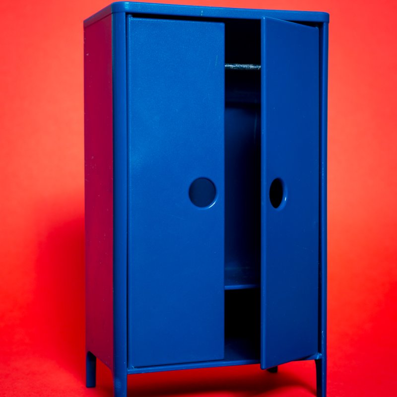 A blue wardrobe against a red background
