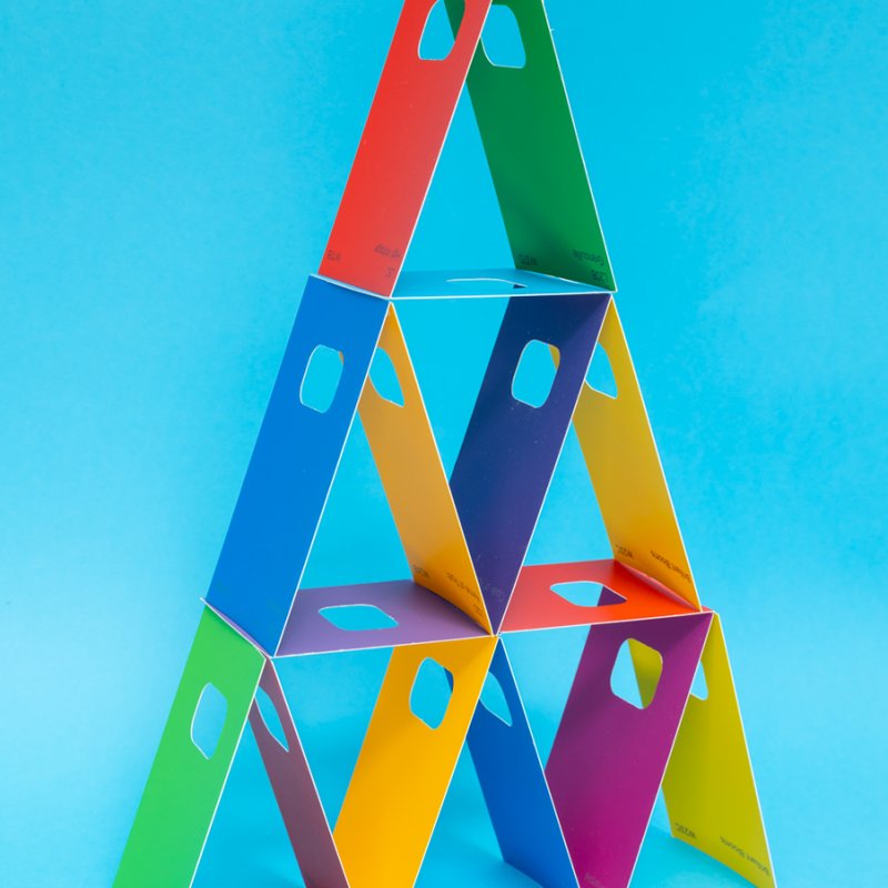 A pyramid of colourful cards against a blue background