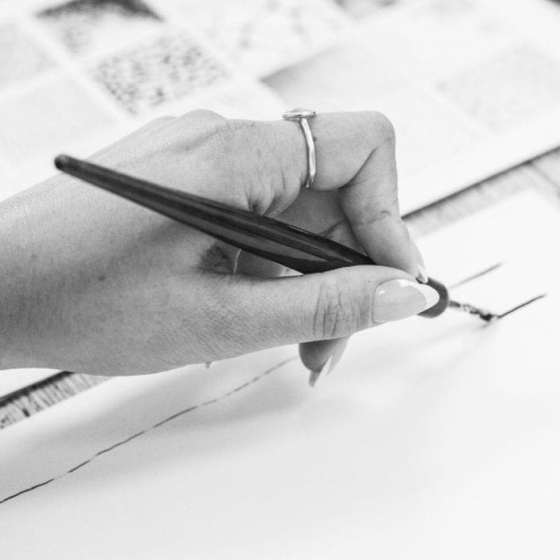 A hand holding a pen