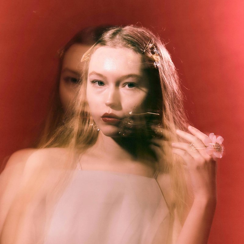 blurred image of a female model in a pink dress