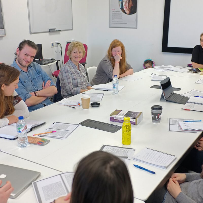 Emily Barr seated with Falmouth University students at a writing workshop