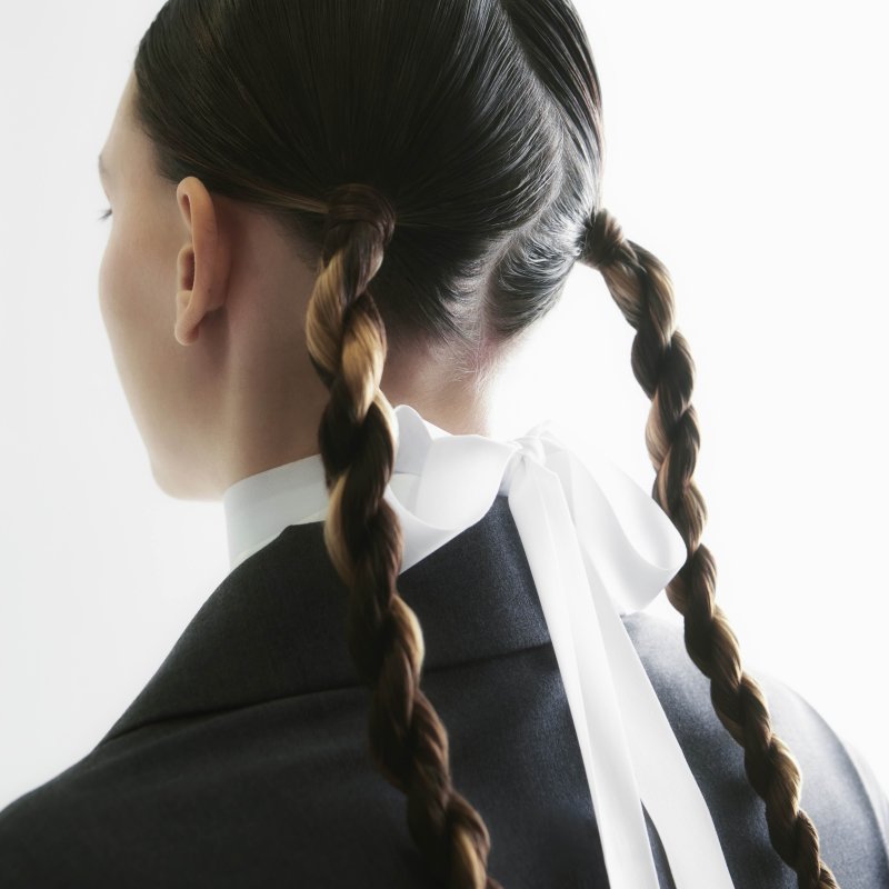 Photo of person looking away with plaited pigtails