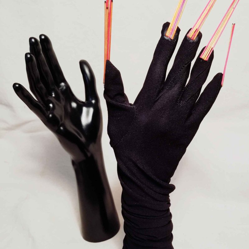 A sculpture of hands with long nails 