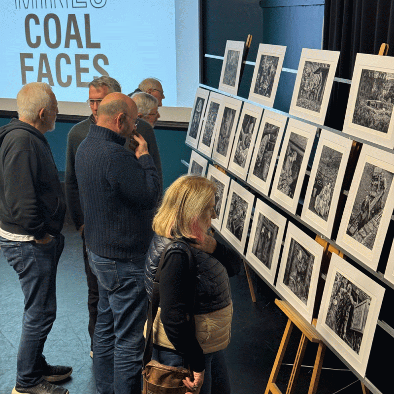 Members of Winchester Photographic Society looking at prints before one of Nick's talks