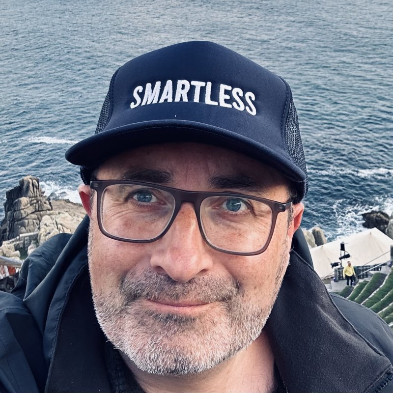 Headshot of comedy writing course leader wearing a cap