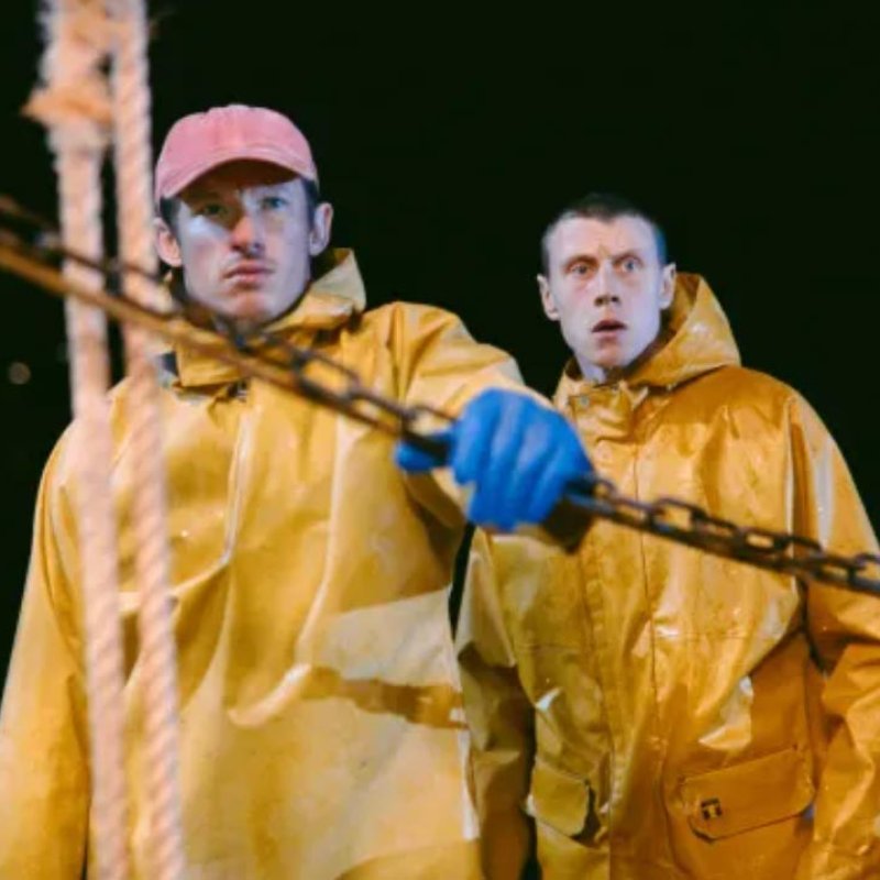 Two men wearing yellow fishermen overalls