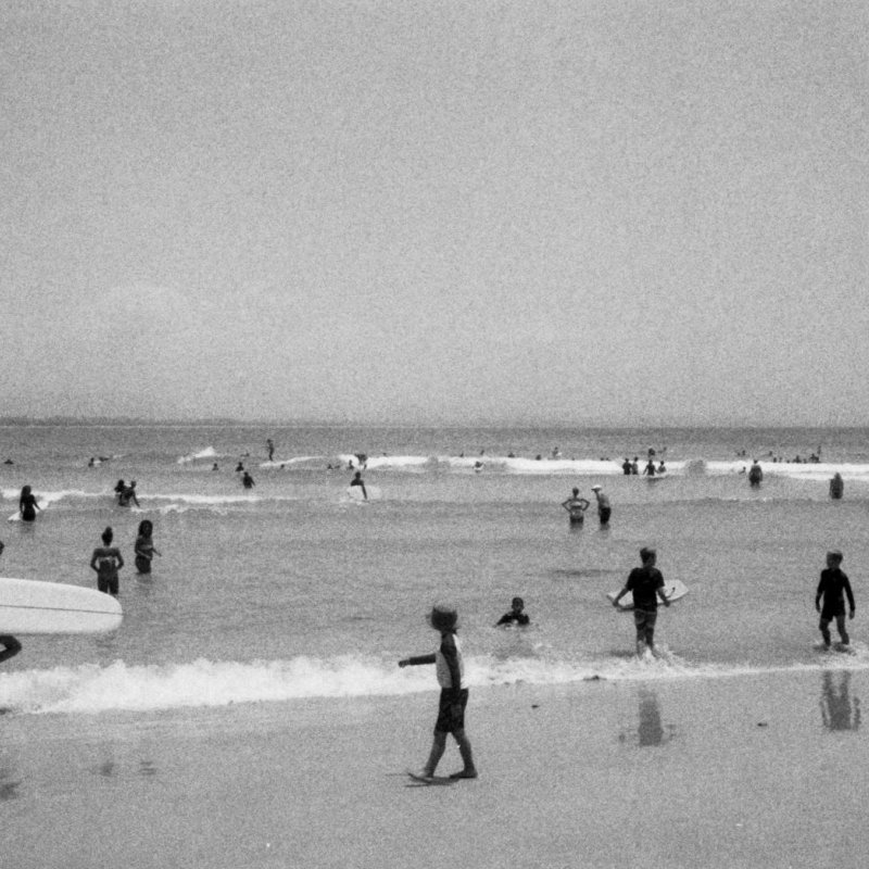 Black and white 35mm film photograph of people on the beach in Cornwall by Abbi Hughes