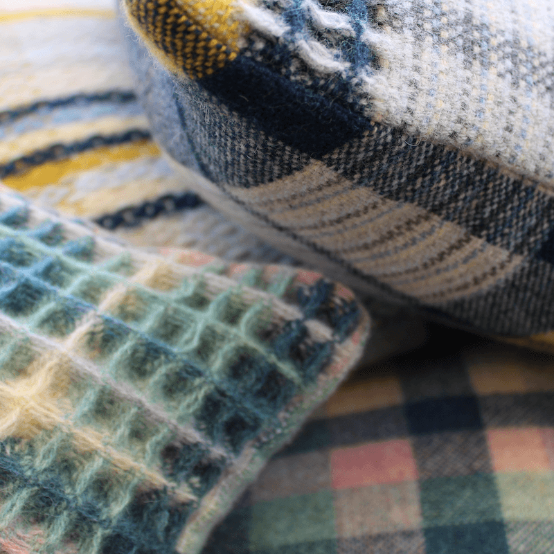 Close up of three hand woven cushions
