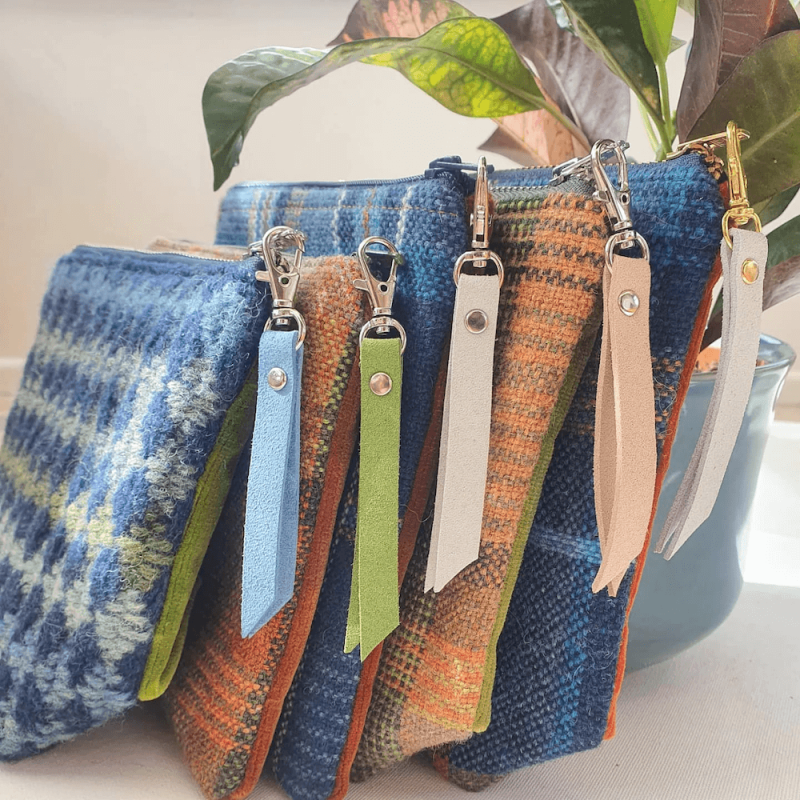 five woven purses with zips and tags