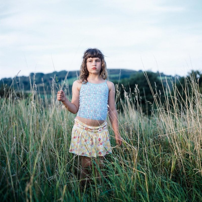 Photograph of a young girl in long grass
