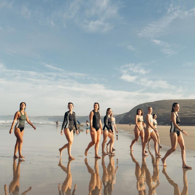 A group of woman walking out of the sea in the sunshine