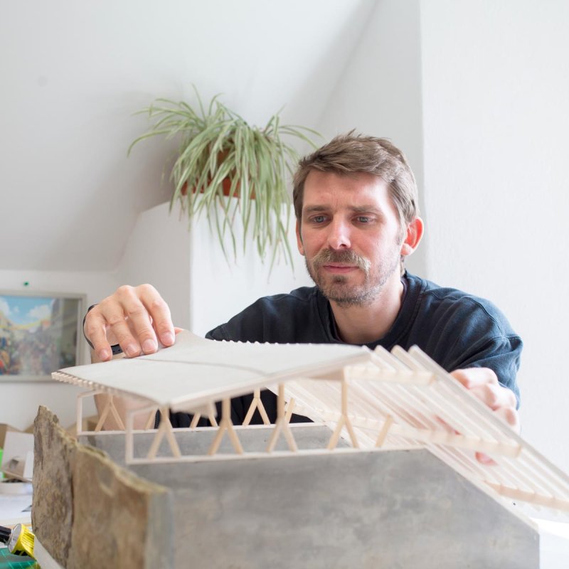 A Falmouth University Architecture student handling a model