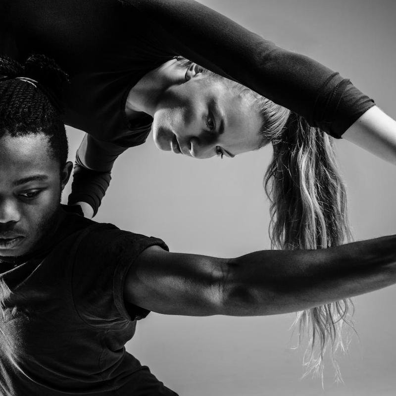 Close up of a male dancer holding a female dancer above his head