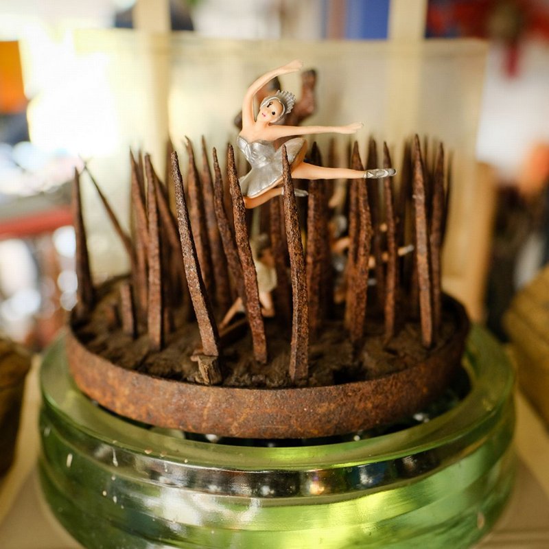 A ballerina dancing on sharp wooden spikes