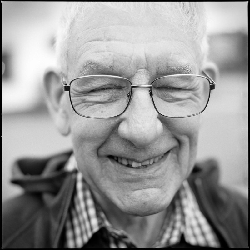 Black and white photo of an elderly man wearing glasses