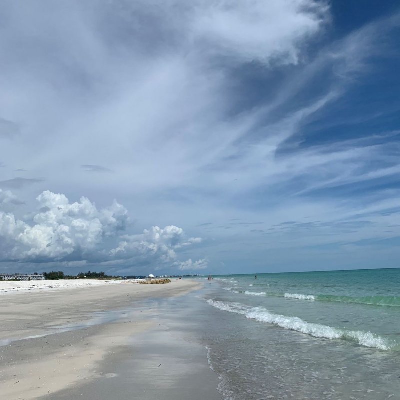 Sandy beach with sea and blue sky