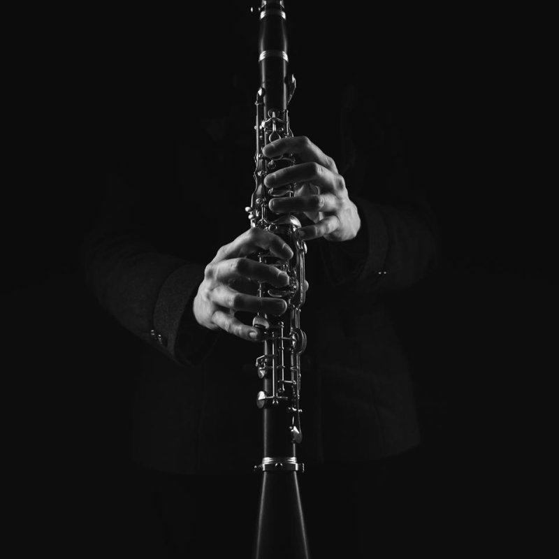 Black and white photo of hands holding a clarinet