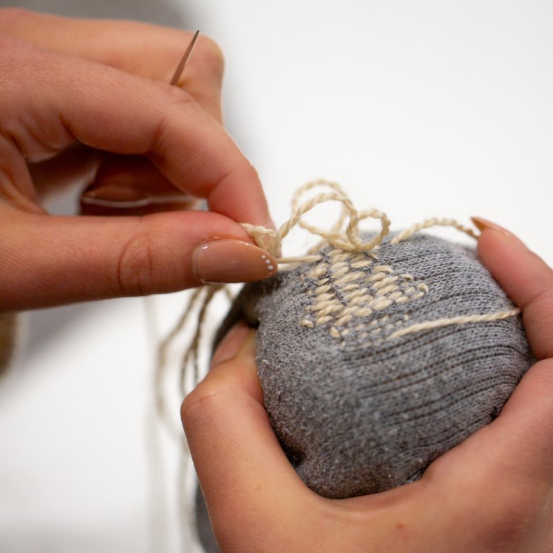 A close-up of someone stitching 