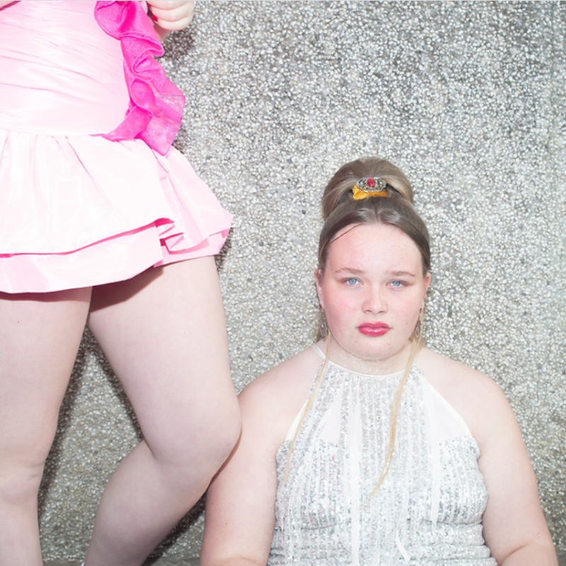 Portrait of Cornish girl wearing dress, makeup and tiara - from Cornish Maids photography project by Fran Rowse