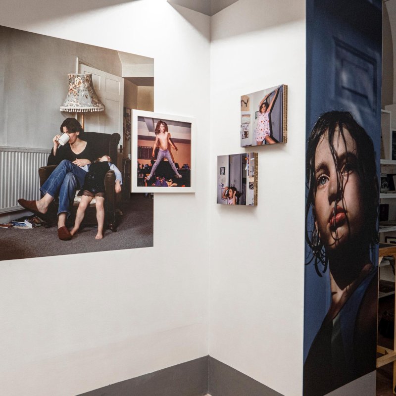 Exhibition of photographs of Colin Pantall's work on a white wall