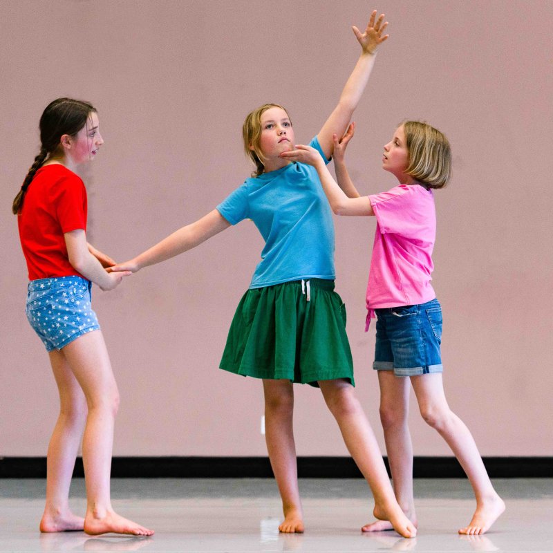 Three children dancing together