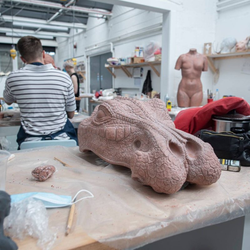 The top half of the dinosaur head cast sits on a worktop
