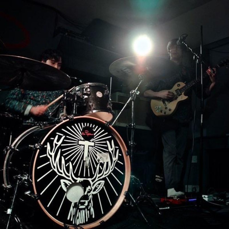 A drummer and a guitarist on stage