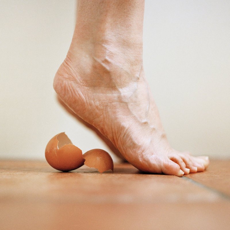 Photography: bare foot on tiptoes about to step back on egg shells