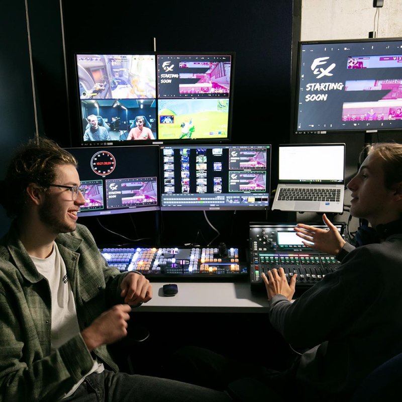 Two male Esports students talking in a studio at Falmouth University