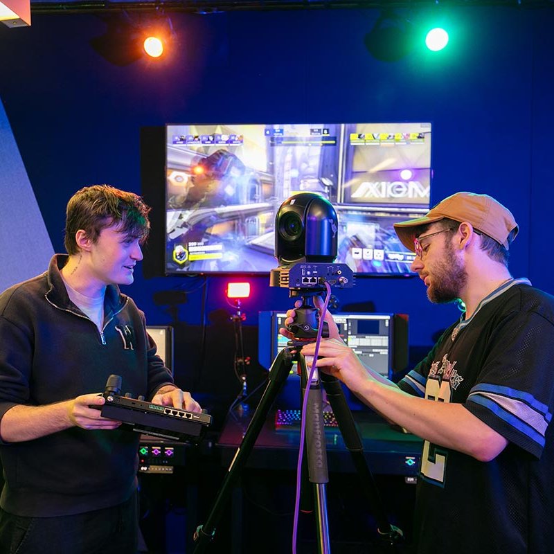 two students working at an esports camera