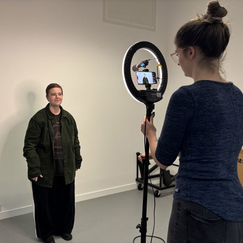 A Musical Theatre student standing in front of someone recording on a phone