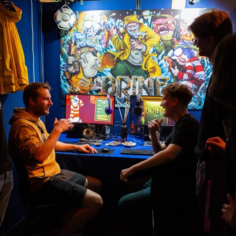 Falmouth University students in an exhibition booth at the 2025 Games Expo